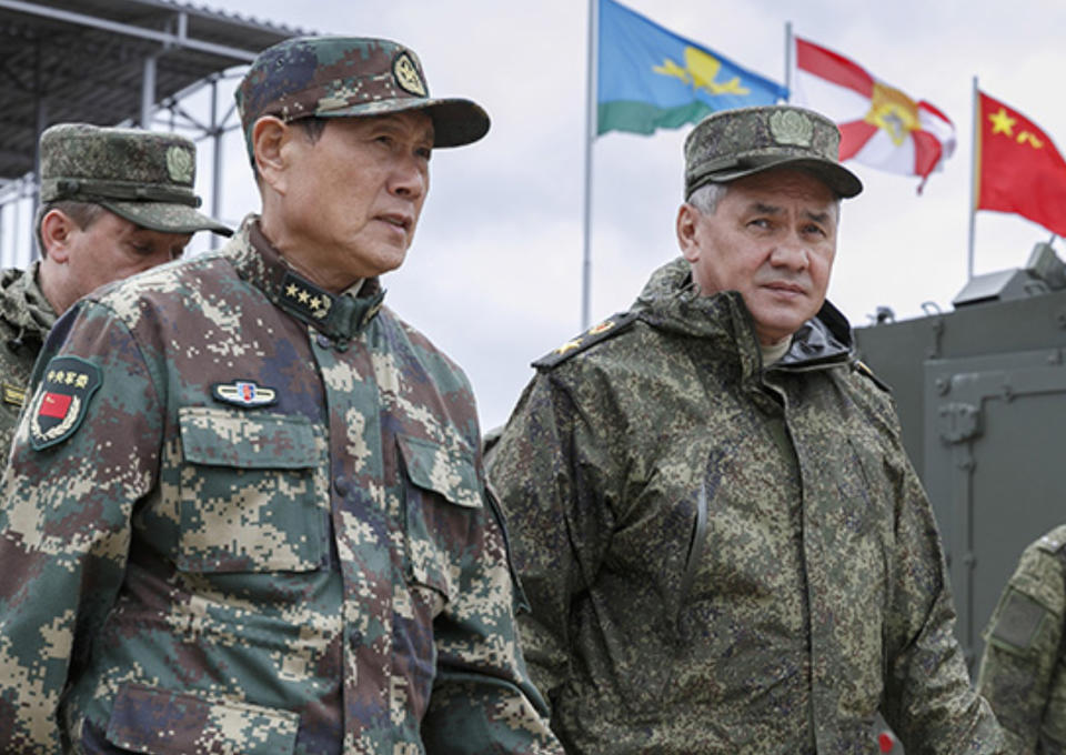 In this photo provided by Russian Defense Ministry Press Service on Wednesday, Sept. 12, 2018, Russian Defense Minister Sergei Shoigu, right, and his Chinese counterpart, Gen. Wei Fenghe, visit the Tsugol firing range in eastern Siberia where nearly 300,000 Russian troops and about 3,200 Chinese troops are participating in joint exercises. (Russian Defense Ministry Press Service pool photo via AP)