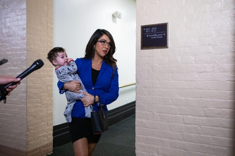 Rep. Lauren Boebert, who represents Colorado’s Third congressional district, has frequently made headlines for her personal life and not politics; the mother of four boys is pictured  holding her new grandson as she arrived for a meeting at the US Capitol last year (Getty Images)