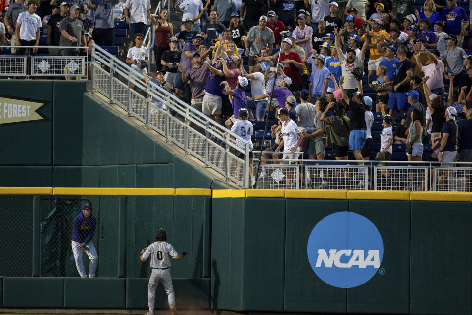 Wake Forest left fielder Lucas Costello (0) watches a game-winning home run by LSU during the 11th inning of a baseball game at the NCAA College World Series in Omaha, Neb., Thursday, June 22, 2023. (AP Photo/John Peterson)