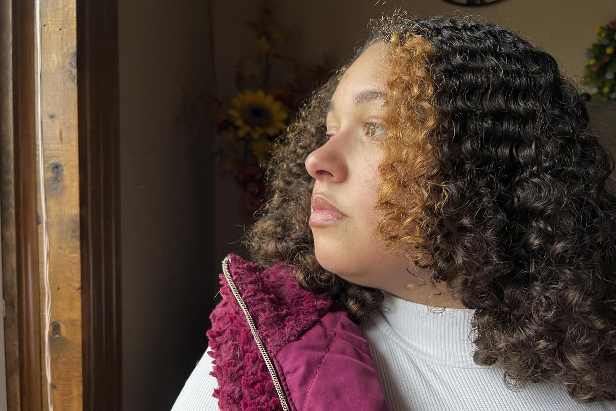 Mia Woodard looks out of a window at her grandmother's home on Wednesday, Feb. 1, 2023 in Jackson, Tenn. Woodard is among hundreds of thousands of Americans who came of age during the pandemic but didn't go to college. She hoped to be the first in her family to get a college degree, but in her senior year, she lost access to counselors and teachers who usually help students navigate college applications. (AP Photo/Patrick Orsagos)