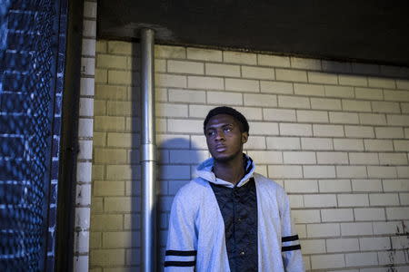 Zumana Karamoko, 19, poses for a photograph on the porch of his family residence in Harlem, New York January 25, 2015. Karamoko says he was 16 years-old when he was incarcerated on Rikers Island in 2012 for armed robbery and two assaults. In an incident after a lockdown, Karamoko says an officer pulled him out of a class, escorted him into another room and started beating him. Karamoko says he attempted to fight back and was beaten by a group of officers and who then hit him with pepper-spray. "When the riot shield guys came, they all jumped me. And then they dragged me all the way to the intake. And I was leaking from my head," he said. Karamoko, who said he was charged and sentenced for assaulting an officer in the incident further states, "My experience at Rikers Island was crazy. The COs (correctional officers) treat inmates bad in there." Rikers, one of the largest jail complexes in the country which houses around 9,800 prisoners, came under scrutiny after the Justice Department in August 2014 issued a report that described a pattern of violent abuse of male inmates aged 16 to 18 by jail staff. In response to questions from Reuters, a spokesman for Rikers Island Department of Correction (DOC) said that, "Since Commissioner (Joseph) Ponte's appointment last year, he has significantly reformed the care and custody of adolescent inmates, resulting in substantial decline in violence in the adolescent facility." The spokesman added that safety for staff and inmates is Commissioner Ponte's "top priority" and that "DOC has a zero-tolerance police with regards to abuse." Reuters has been unable to independently verify the statements provided by the individual in this portrait. Picture taken January 25, 2015. REUTERS/Elizabeth Shafiroff