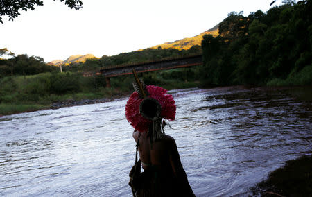 An Indigenous woman from the Pataxo Ha-ha-hae tribe looks at Paraopeba river, after a tailings dam owned by Brazilian mining company Vale SA collapsed, in Sao Joaquim de Bicas near Brumadinho, Brazil January 28, 2019. REUTERS/Adriano Machado