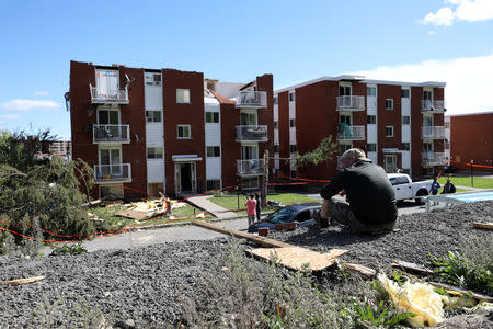 People look at the damaged buildings after a tornado hit the Mont-Bleu neighbourhood in Gatineau, Quebec, Canada, September 22, 2018. REUTERS/Chris Wattie