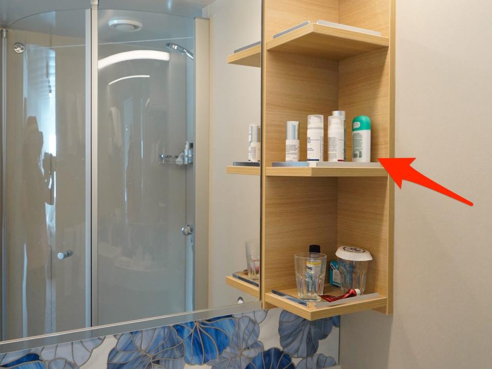 An arrow points to the author's toiletries in the cabin bathroom