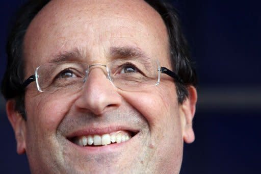 France's Socialist Party candidate in the 2012 French presidential election Francois Hollande smiles during his visit in the northern French city of Hirson