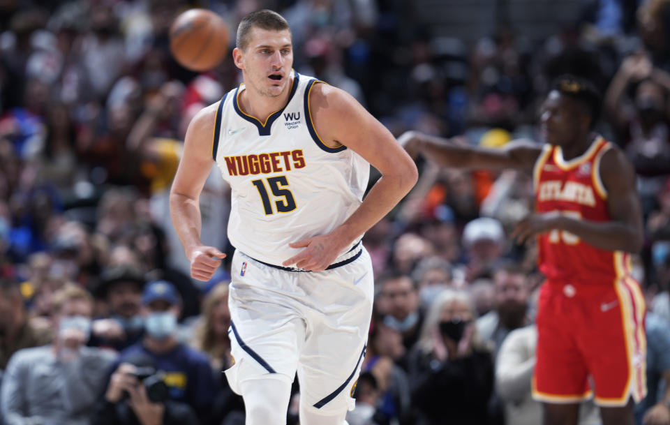 Denver Nuggets center Nikola Jokic heads to the other end of the court after hitting a basket against the Atlanta Hawks during the first half of an NBA basketball game Friday, Nov. 12, 2021, in Denver. (AP Photo/David Zalubowski)