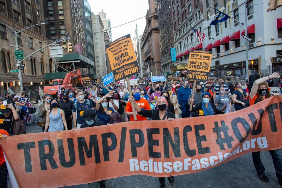 People march as they celebrate in New York after Joe Biden was declared winner of the 2020 presidential election. (Photo by Kena Betancur / various sources / AFP) (Photo by KENA BETANCUR/AFP via Getty Images)