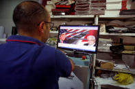 A Palestinian man prints posters depicting U.S. President Donald Trump in preparations for his planned visit, in the West Bank town of Bethlehem May 21, 2017. REUTERS/Mussa Qawasma