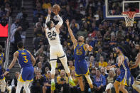 Memphis Grizzlies forward Dillon Brooks (24) shoots over Golden State Warriors guard Stephen Curry (30) during the first half of Game 6 of an NBA basketball Western Conference playoff semifinal in San Francisco, Friday, May 13, 2022. (AP Photo/Tony Avelar)