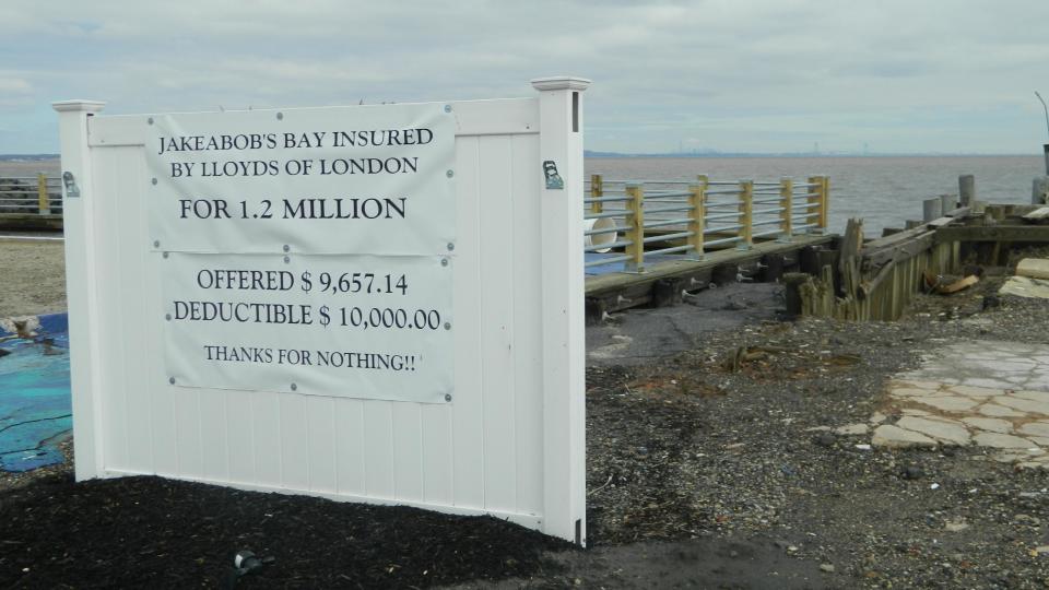 This March 31, 2014 photo shows a sign erected at the site of the former Jakeabob's restaurant in Union Beach, N.J., whose owner is embroiled in a dispute with insurer Lloyd's of London over the proposed payout on a policy she had before Superstorm Sandy destroyed the business, Gigi Liaguno-Dorr rented space inland for the business last summer, but closed it down for good on March 28 due to a continuing inability to get rebuilding funds. (AP Photo/Wayne Parry)