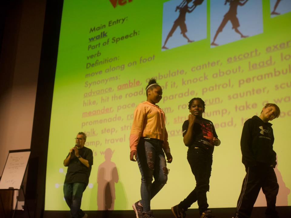 Chris Grabenstein invited three students from each presentation on stage with him to help illustrate the power of strong verbs as he had them walk and strut across the stage.