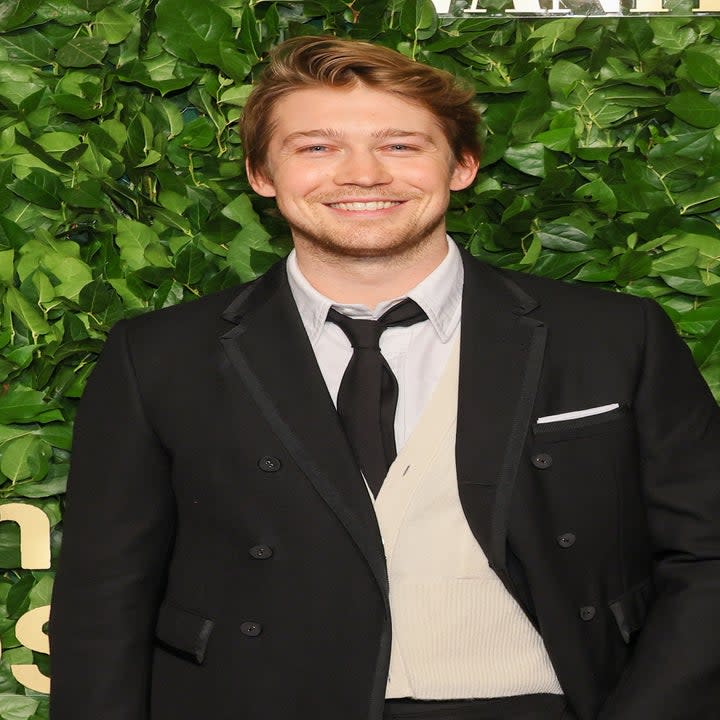 A close-up of Joe smiling at a red carpet event