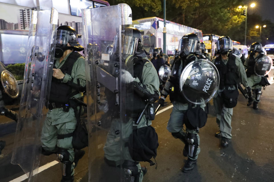 Police march in riot gear near the Tsim Sha Tsui police station in Hong Kong on Saturday, Aug. 10, 2019. Hong Kong is in its ninth week of demonstrations that began in response to a proposed extradition law but have expanded to include other grievances and demands for more democratic freedoms. (AP Photo/Vincent Thian)