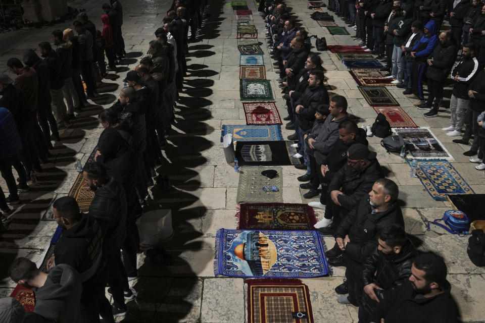 Muslim worshippers perform "tarawih," an extra lengthy prayer held during the Muslim holy month of Ramadan, at the Al-Aqsa Mosque compound in the Old City of Jerusalem, Saturday, March 16, 2024. (AP Photo/Mahmoud Illean)