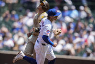 Chicago Cubs shortstop Nico Hoerner, right, forces out San Diego Padres' Manny Machado at second base during the first inning of a baseball game Wednesday, May 8, 2024, in Chicago. (AP Photo/Erin Hooley)