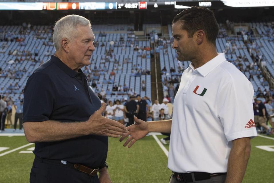 UNC head coach Mack Brown and Miami coach Manny Diaz meet before the game as the Hurricanes play against the University of North Carolina - Chapel Hill at Kenan Stadium in Chapel Hill, NC on Saturday, September 7, 2019.