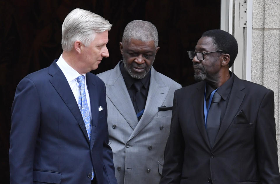 Belgium's King Philippe, left, speaks with the children of Congo's former prime minister Patrice Lumumba, from right, Francois and Roland, at the Royal Palace in Brussels, Monday, June 20, 2022. On Monday, more than sixty one years after his death, the remains of Congo's first democratically elected prime minister Patrice Lumumba will be handed over to his children during an official ceremony in Belgium. (AP Photo/Geert Vanden Wijngaert)