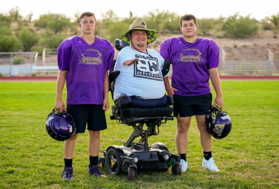Wickenburg High School assistant football coach Carter Crosland (center) poses for a photo with his cousins Jaxson (left) and Carson Hone who play for the team.