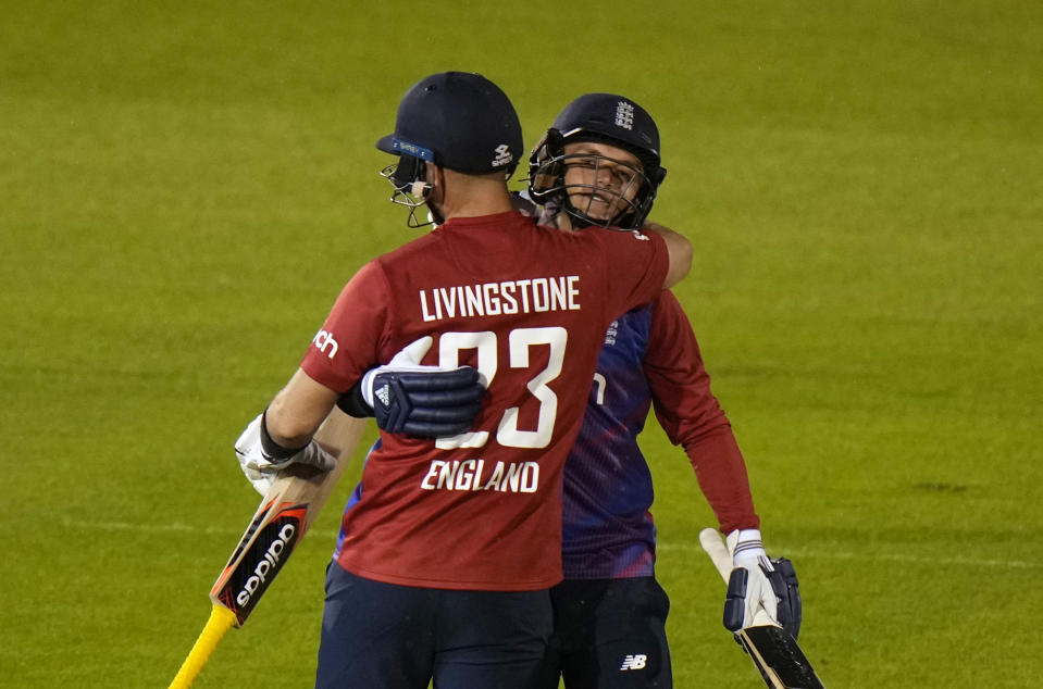 England's Sam Curran, right, hugs teammate England's Liam Livingstone, after defeating Sir Lanka in the second T20 international cricket match between England and Sri Lanka in Cardiff, Wales, Thursday, June 24, 2021. (AP Photo/Alastair Grant)