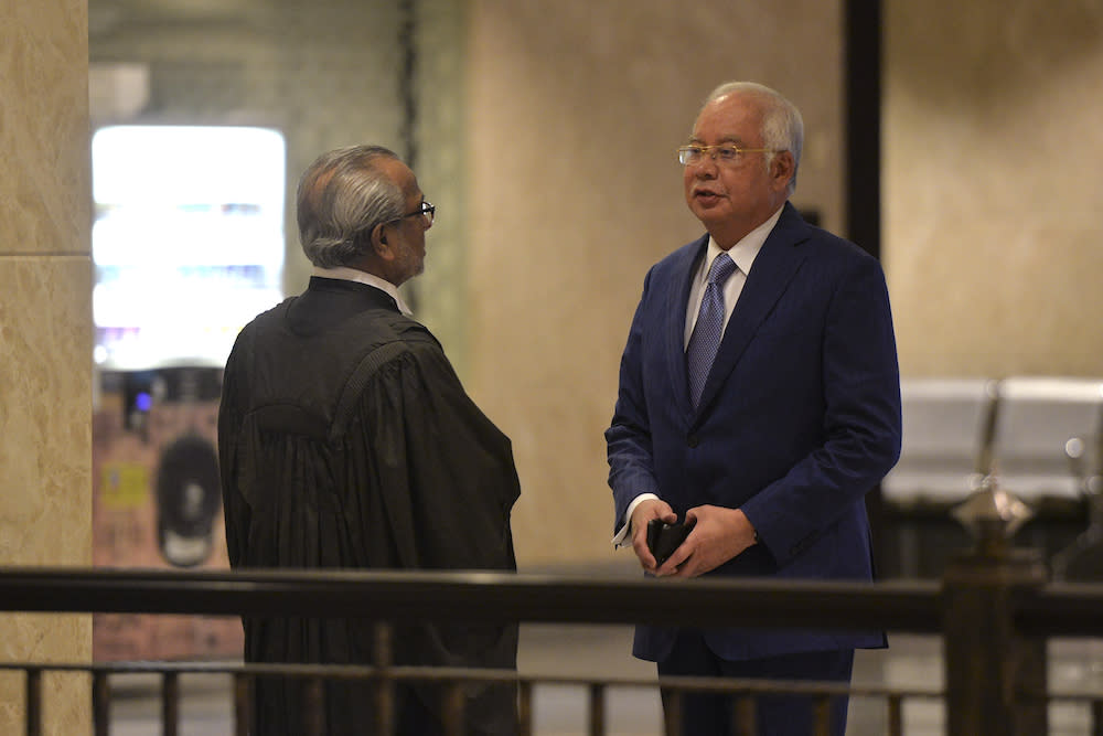 Datuk Seri Najib Razak confers with his lawyer, Tan Sri Muhammad Shafee Abdullah, at the Palace of Justice in Putrajaya August 13, 2019. — Picture by Shafwan Zaidon