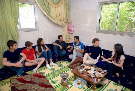 Syria's President Bashar al-Assad, accompanied by his wife Asma (2nd R) and family, visit an injured soldier in Hama province. SANA/via REUTERS