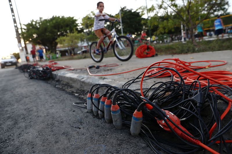 A child rides a bicycle past subsoil monitoring equipment installed to track effects of rock salt mining by the petrochemical company Braskem in Maceio