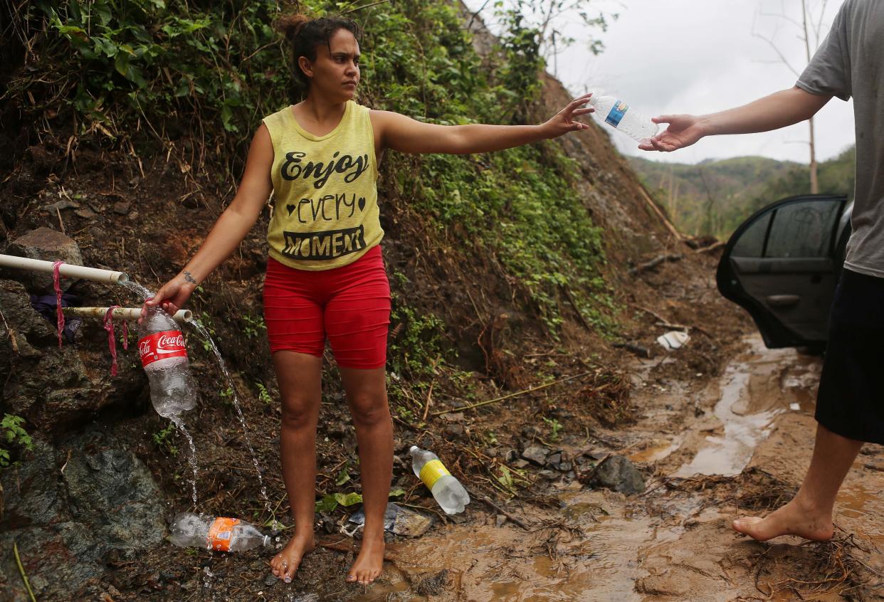 Puerto Rican resident Yanira Rios collects spring water nearly three weeks after Hurricane Maria destroyed her town of Utuado, which still has little running water or power. (Photo: Mario Tama via Getty Images)