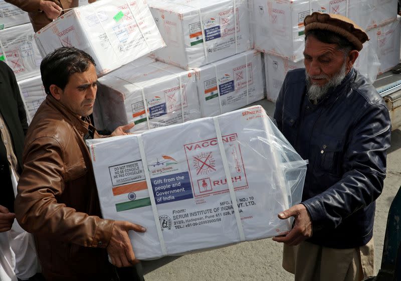 FILE PHOTO: Workers from Afghan health ministry unload boxes containing vials of COVISHIELD, a coronavirus disease (COVID-19) vaccine donated by Indian government, in Kabul