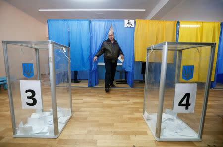 A voter walks out of a booth at a polling station during the second round of a presidential election in Kiev, Ukraine April 21, 2019. REUTERS/Valentyn Ogirenko