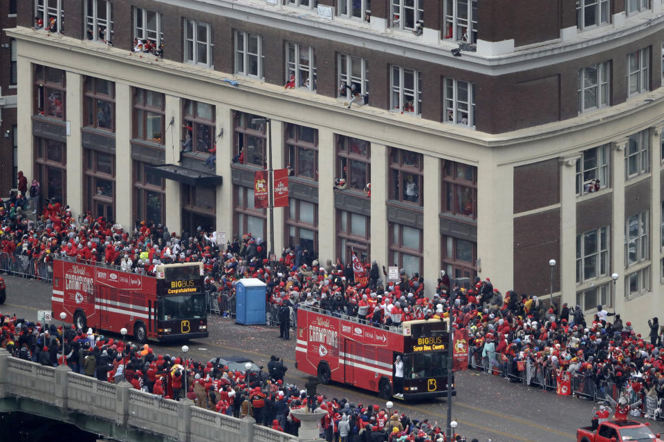 Busses carrying members of the Kansas City Chiefs travel in a parade through downtown Kansas City, Mo., Wednesday, Feb. 5, 2020, to celebrate the Chiefs victory in the NFL's Super Bowl 54. (AP Photo/Charlie Riedel)