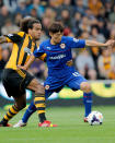 Cardiff City's Kim Bo Kyung (right) and Hull City Tigers' Tom Huddlestone during the Barclays Premier League match at the KC Stadium, Hull.
