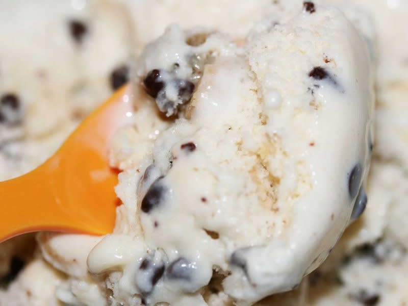 Chocolate chip cookie dough ice cream with orange spoon