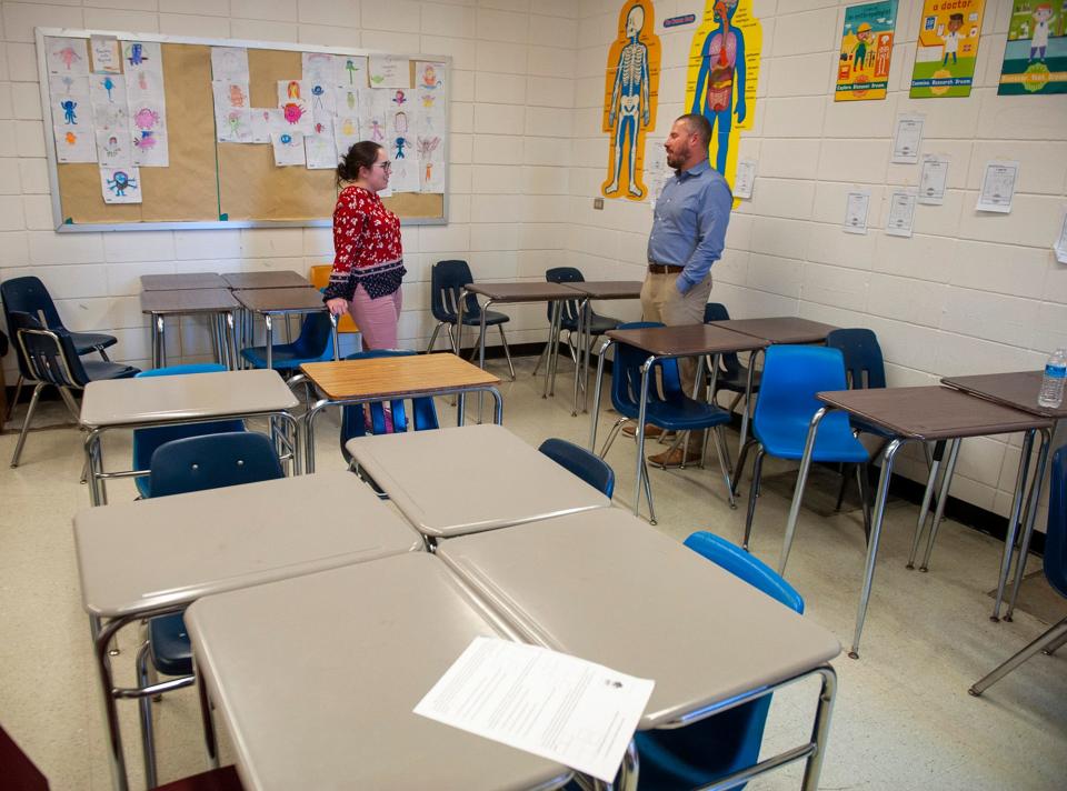 Milford High School science teacher Catherine Neville and Principal Josh Otlin chat inside a classroom back in March. The Massachusetts School Board Authority has voted to invite Milford High into its eligibility phase, marking a key step forward in potentially getting upgrades or even a new school.