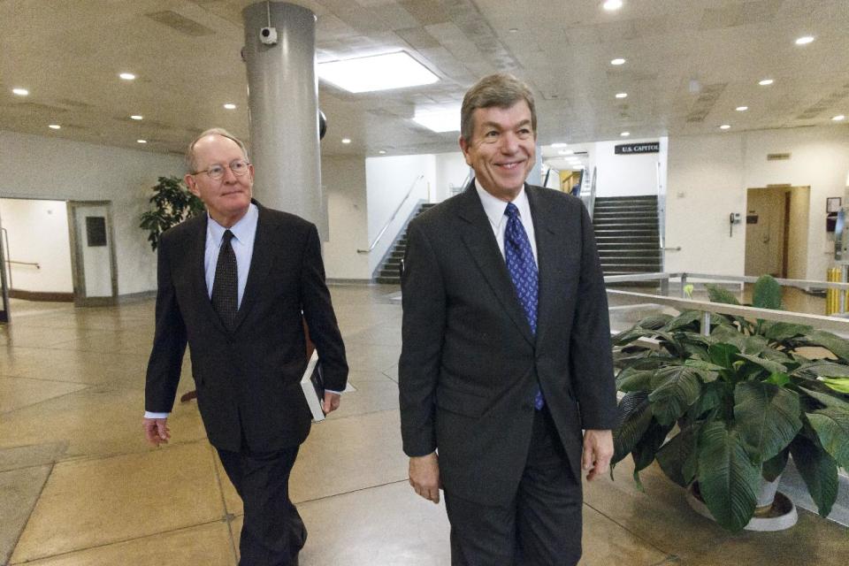 Sen. Lamar Alexander, R-Tenn., left, and Sen. Roy Blunt, R-Mo. return to their offices on Capitol Hill in Washington, Thursday, Jan. 16, 2014, during a short recess as the Senate worked to get final congressional approval for an immense $1.1 trillion spending package, a bipartisan compromise that all but banishes the likelihood of an election-year government shutdown, Thursday, Jan. 16, 2014. The legislation is a follow-up to the budget compromise the two parties pushed through Congress in December that set overall spending limits for the next two years. (AP Photo/J. Scott Applewhite)