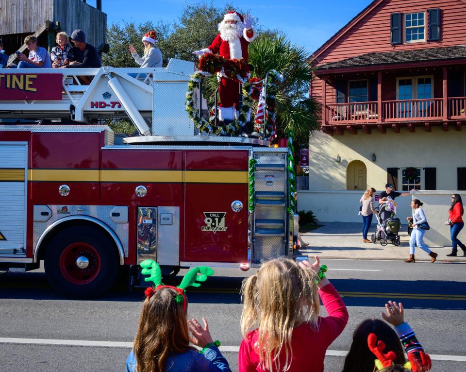 Santa Claus waves to the crowd from the top of a St. Augustine Fire Department ladder truck at the end of the city’s annual Christmas Parade through the city on Saturday, Dec. 4, 2021.