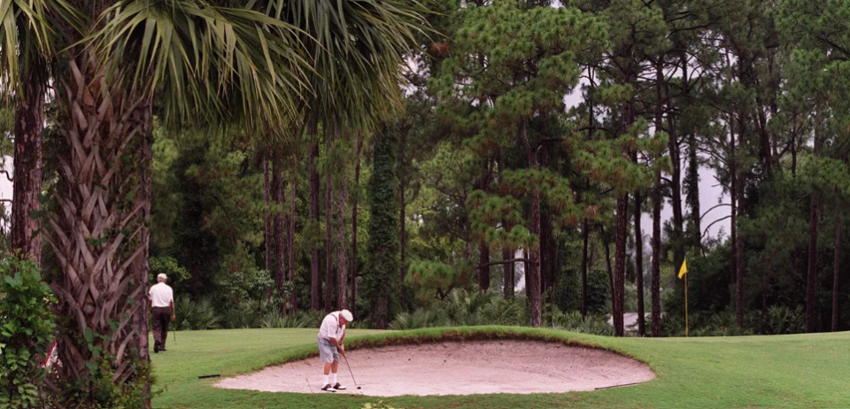 In this June 2001 photo, a golfer plays out of a sand trap at Forest Oaks, west of Lake Worth Beach. The 79-acre course, after years of litigation, will soon become the site of a 450-unit development to be built by Mattamy Homes.