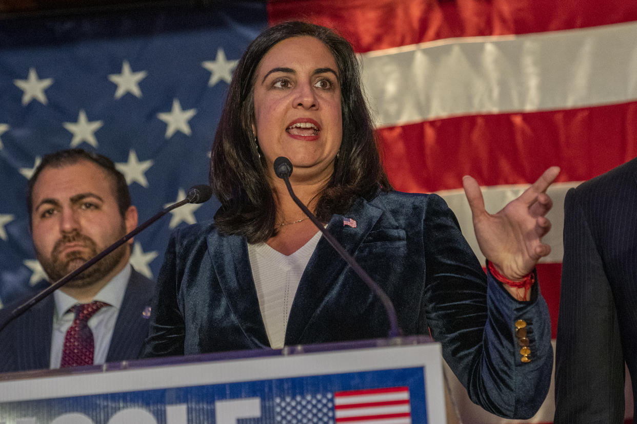 Nicole Malliotakis speaks at a podium in front of an American flag.