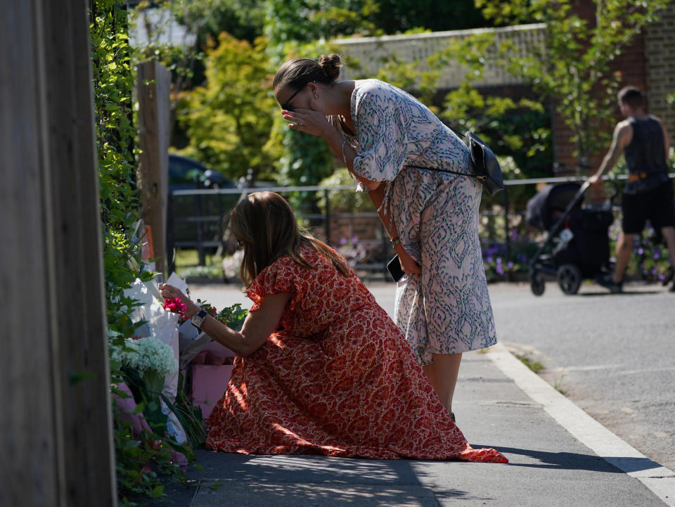 People look at flowers and messages left outside the Study Preparatory School in Wimbledon, south-west London. (Getty)