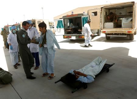 Injured members of the Afghan security forces wait for air transport to take them for treatment in Kabul, at the Kandahar military Airport, Afghanistan July 9, 2017. REUTERS/Omar Sobhani