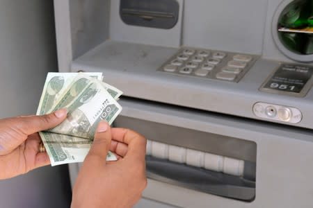 A client uses an automated teller machine (ATM) at the Commercial Bank of Ethiopia in Addis Ababa