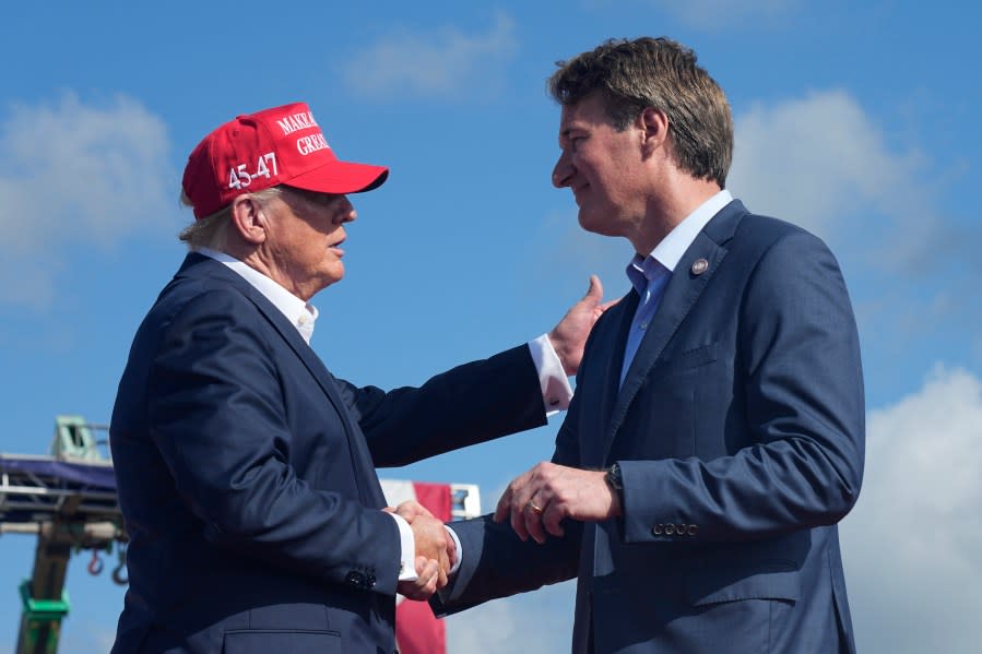 Republican presidential candidate former President Donald Trump, left, greets Virginia Gov. Glenn Youngkin, at a campaign rally in Chesapeake, Va., Friday June 28, 2024. (AP Photo/Steve Helber)