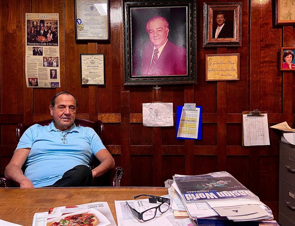 Monte Ferris sits in the office of his Venus de Milo banquet facility in Swansea with a photo of his late father Monsour Ferris on the wall.