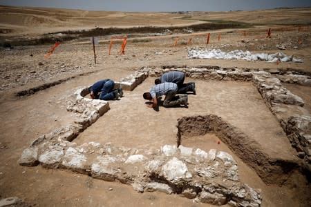 Workers pray inside the remains of a mosque discovered by the Israel Antiquities Authority and which they say is one of the world's oldest mosques, in the outskirts of the Bedouin town of Rahat in southern Israel