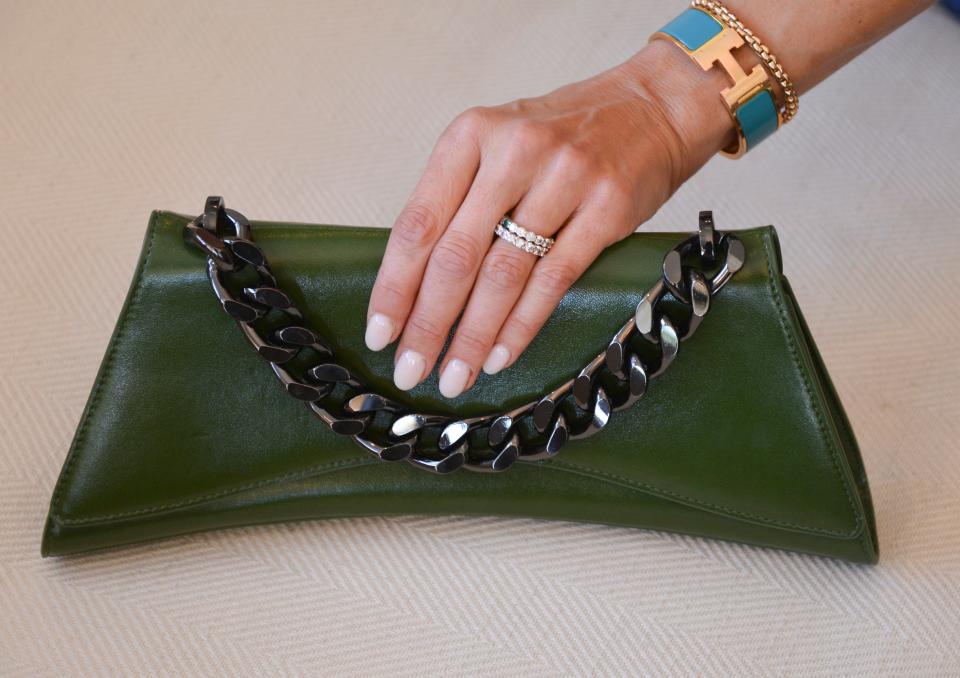 Leigh Dorough holds an Eslla Satori Clutch in her Indian Harbour Beach home.