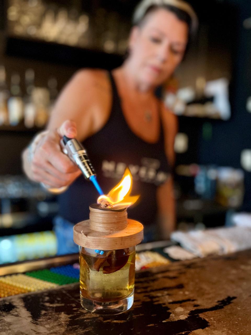 Michelle Westman prepares a cocktail at Nevermind Awesome Bar & Eatery in Cape Coral.