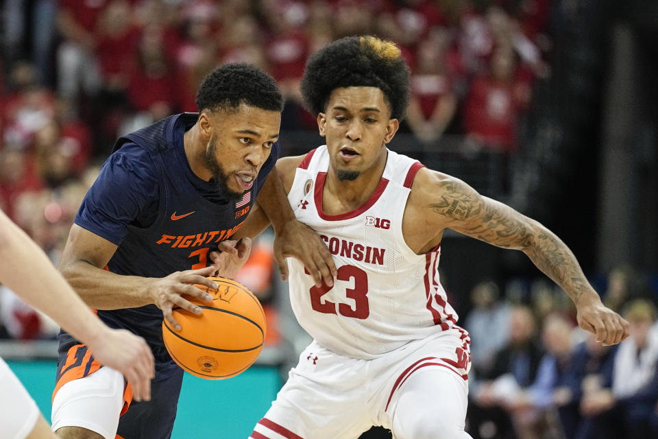 Illinois's Jayden Epps drives against Wisconsin's Chucky Hepburn (23) during the first half of an NCAA college basketball game Saturday, Jan. 28, 2023, in Madison, Wis. (AP Photo/Andy Manis)