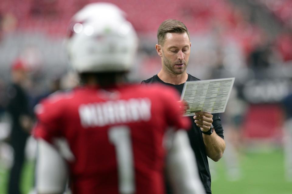 Oct 24, 2021; Glendale, Arizona, USA; Arizona Cardinals head coach Kliff Kingsbury looks on as Arizona Cardinals quarterback Kyler Murray (1) warms up prior to the game against the Houston Texans at State Farm Stadium.