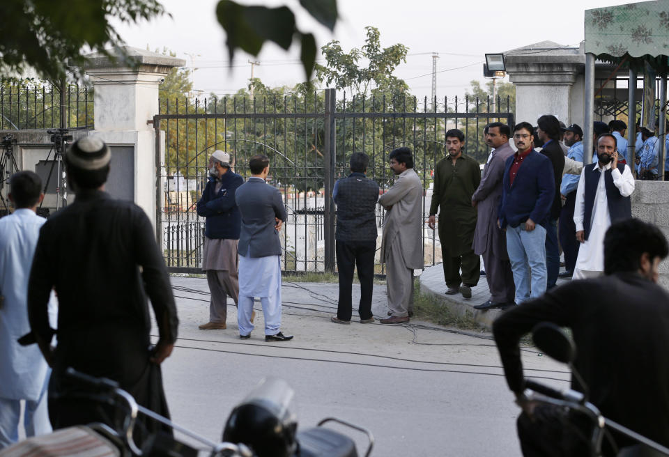 Supporters of Pakistan's ailing former Prime Minister Nawaz Sharif gather at an entrance of Islamabad High Court, in Islamabad, Pakistan, Saturday, Oct. 26, 2019. An Islamabad court is holding an emergency hearing to decide whether to free Sharif, convicted on money-laundering and corruption at charges. (AP Photo/Anjum Naveed)