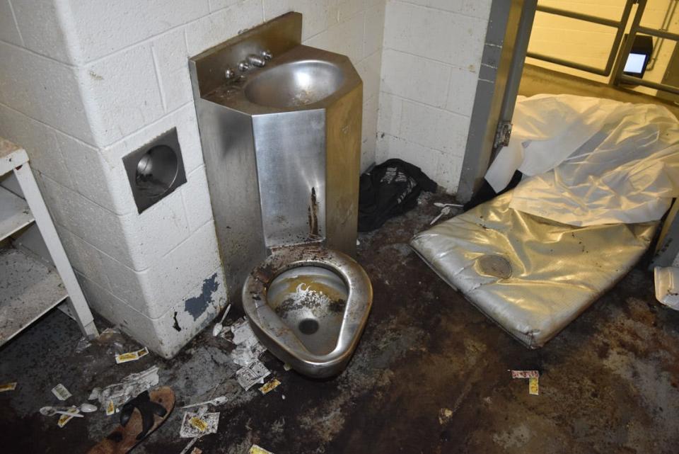 Photos of the jail cell where Lashawn Thompson was held show squalid conditions.
