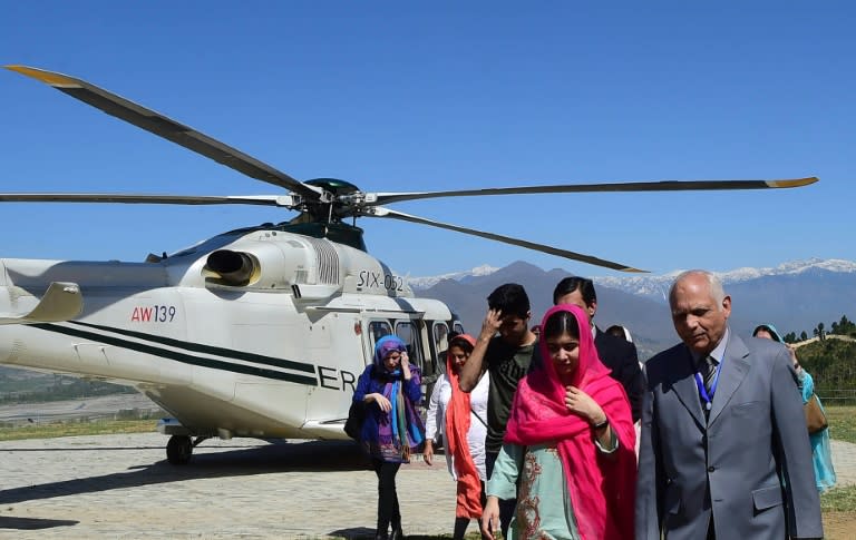 Malala Yousafzai (2R) arrived by army helicopter on her first visit to Swat valley since she was shot by the Taliban more than five years ago